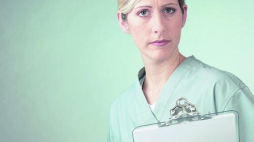 A nurse holding a clipboard.