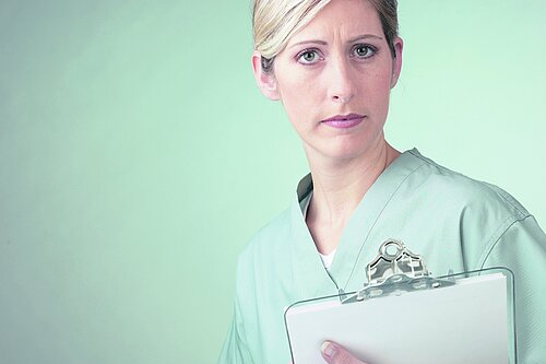 A nurse holding a clipboard.